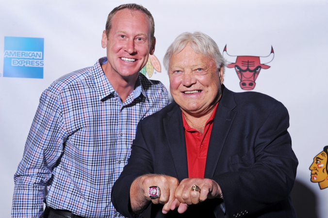 Chicago Blackhawks legend Bobby Hull poses with excited fan, shows his championship rings  off on the step and repeat