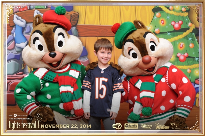 Chip and Dale pose with young fan on the step and repeat background, Magnificent Mile Festival of Lights Parade 2014