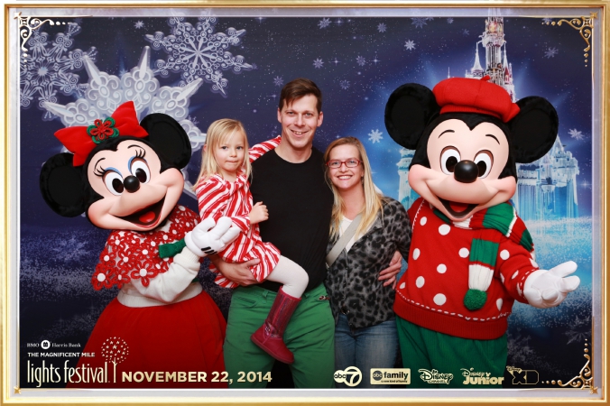 Handsome family poses with Mickey and Minnie Mouse at abc7 Disney character meet and greet, festival of lights, downtown chicago