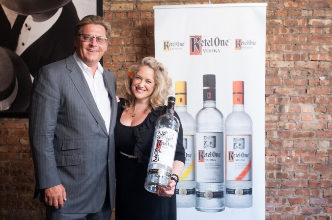 Ketel One Vodka owner Carl Notel Jr poses on the step and repeat for an exclusive bottle signing event, chicago