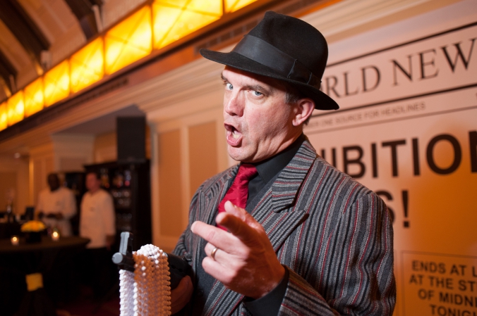 actor in gangster character, roaring 20s speakeasy theme cocktail hour