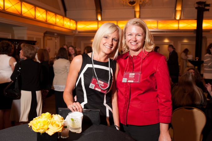 posed event photo of organizer of annual womens conference  speakeasy theme cocktail hour