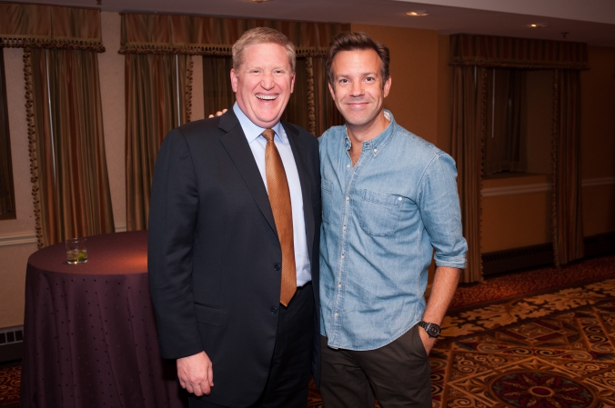 snl star jason sudeikis poses with applebees CEO after private performance with second city at applebee's annual sales meeting, intercontinental chicago