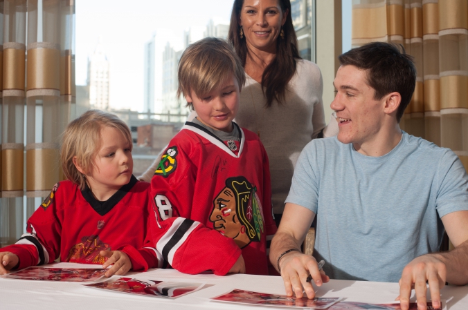 sports celebrity photo of young fans meet and greet with chicago blackhawks andrew shaw.