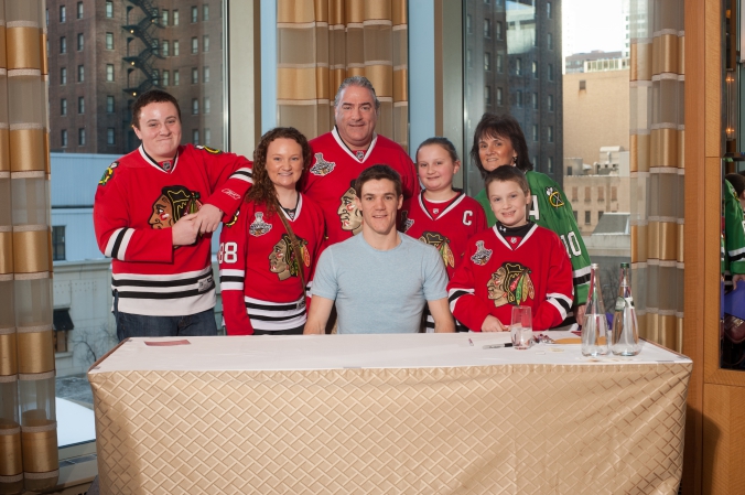 sports celebrity photo of chicago family blackhawk fans meet and greet with andrew shaw.