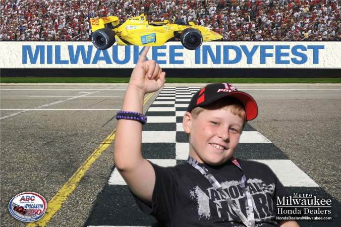 proud kid balances formula car on little finger, green screen photography magic by fab photo chicago, milwaukee indyfest