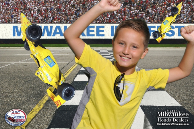 yellow shirt kid poses with flying formula cars in fabphotochicago green screen photography, milwaukee indyfest