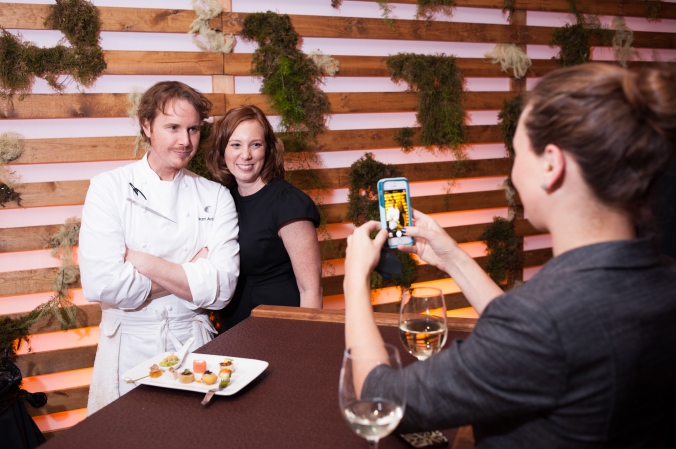 Grant Achatz poses wtih guest at private celebrity chef event in downtown chicago.