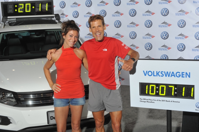ultra marathon man dean karnazes poses with fan and official pace car volkswagen tiguan chicago marathon 2011, photo printed instanly onsite