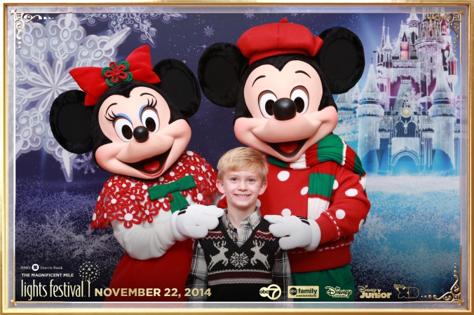 mickey and minnie mouse pose for onsite instant photo print at festival of lights event, chicago