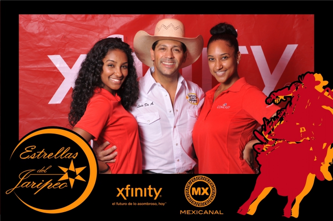 star of estrellas del jaripeo poses with two lovely ladies for xfinity mexicanal step repeat photo activity with onsite photo printing