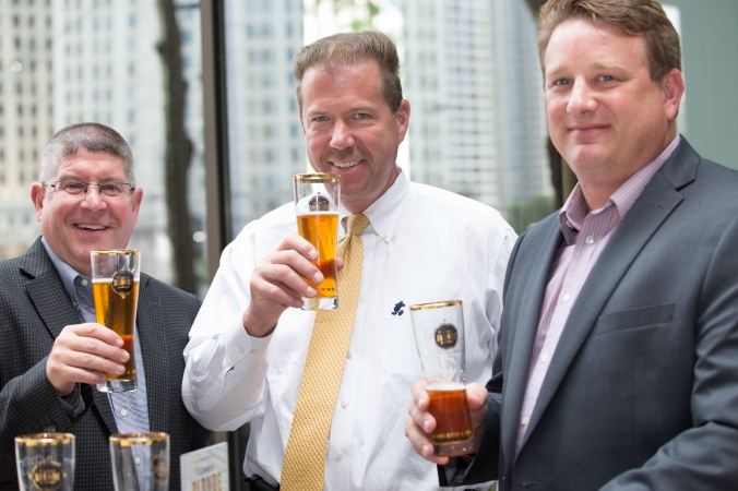 tres hombres enjoy guinness at beer tasting event, downtown chicago