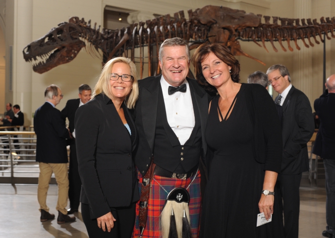 group photo at private field museum event, sue the dinosaur in background