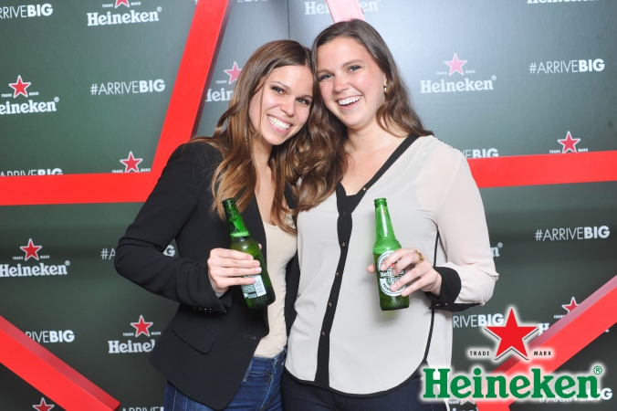cute girls pose with new heineken bottles, step repeat photography, new bottle activation event