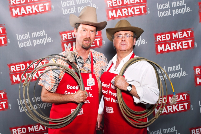 red meat market owner pose for step repeat photo at chicago launch party