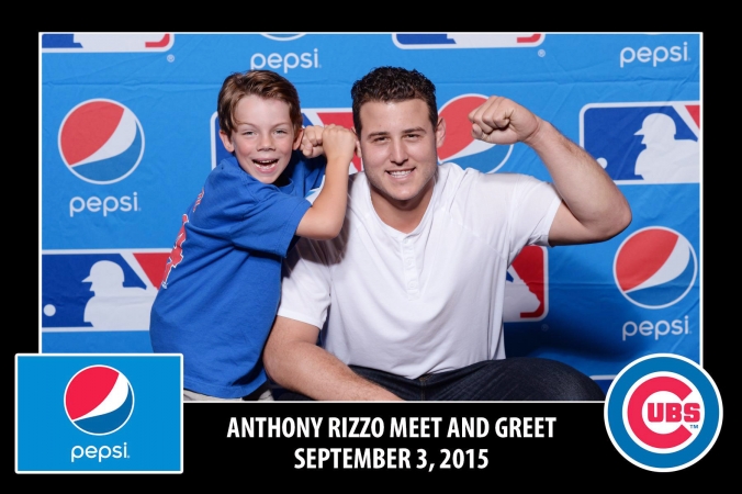 MBL All Star Anthony Rizzo poses with child at FAB Photos step and repeat photo booth. 